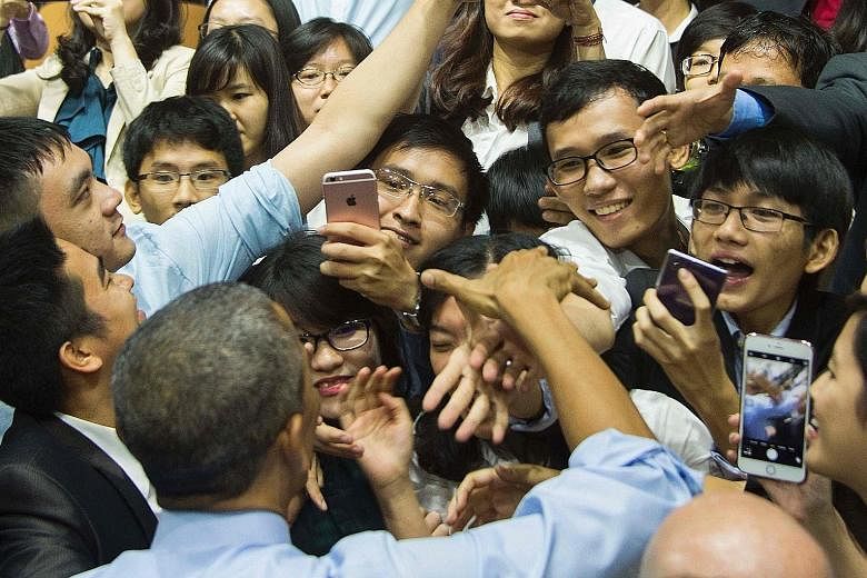 Mr Barack Obama (bottom left) greeting audience members after the Young South-east Asian Leaders Initiative town hall event in Ho Chi Minh City yesterday.