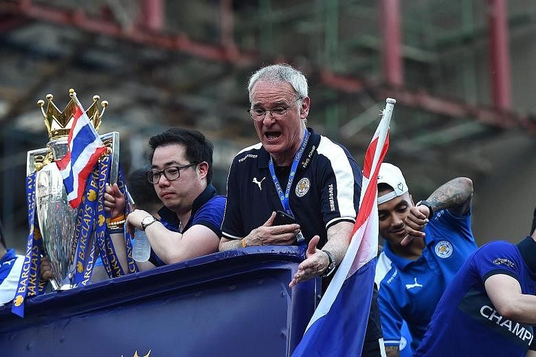 Leicester City manager Claudio Ranieri and his players showing their delight during an open-bus parade in Bangkok last week. Vice-chairman Aiyawatt Srivaddhanaprabha, son of the owner, is holding the Premier League trophy.