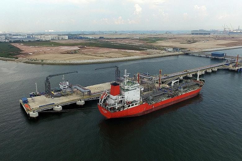 The Singapore Lube Park in Tuas houses shared facilities such as an import-export jetty (above), pipelines and a tank farm (left).