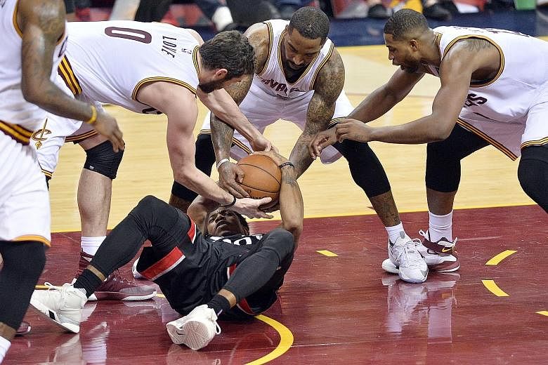 Cavaliers forward Kevin Love (left), guard J.R. Smith (centre) and centre Tristan Thompson (right) battle with Raptors guard DeMar DeRozan for a loose ball at the Quicken Loans Arena. Cleveland held DeRozan to just 14 points, while Toronto's other da