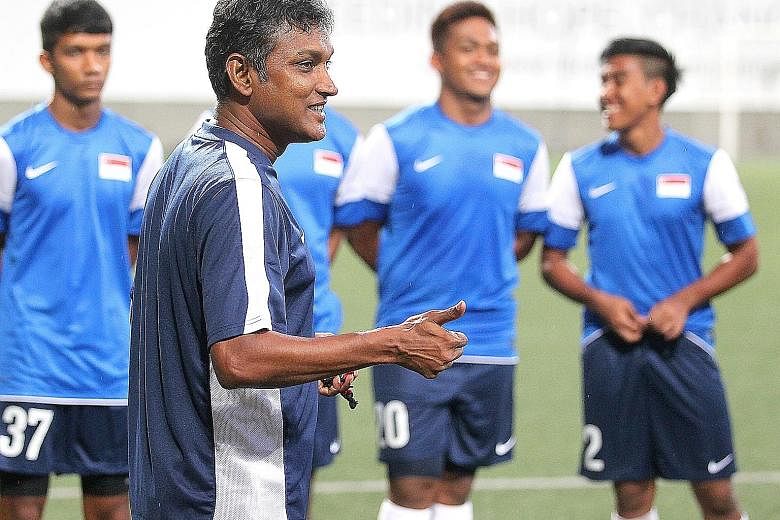 V. Sundramoorthy (foreground) coaching Singapore's SEA Games team in 2013. The former Singapore striker has also worked with current Lions in his time at the Young Lions and LionsXII.