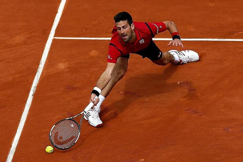 Novak Djokovic stretches to return a dropshot by Belgian veteran Steve Darcis during their French Open second round clash. The Serb prevailed in straight sets despite making 42 unforced errors.