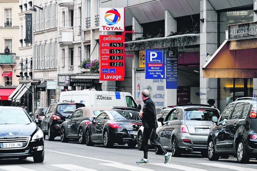 Drivers forming a queue yesterday at a petrol station in Paris amid blockades of several oil depots by protesters opposed to labour law reforms that make it easier to hire and fire workers.