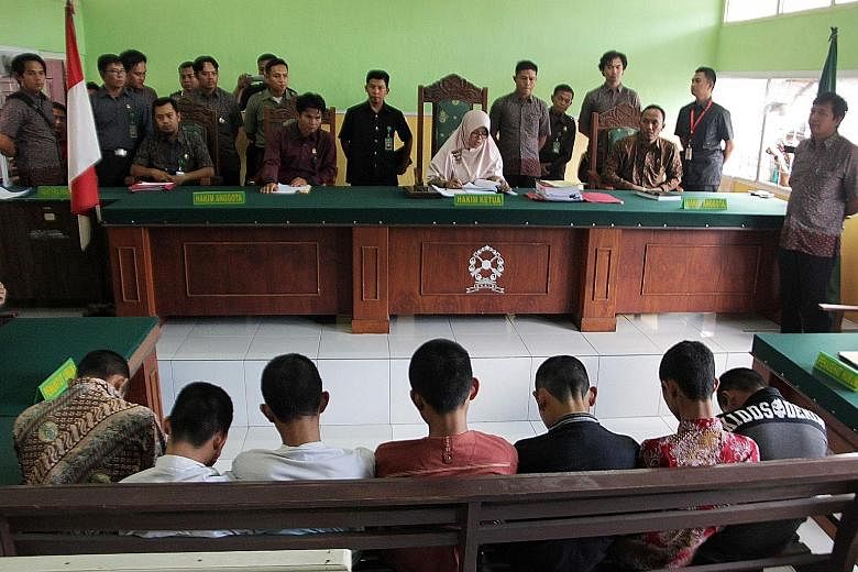 A judge (wearing a veil) delivering her sentence to seven accused teenagers in Curup, Bengkulu province, on May 10.