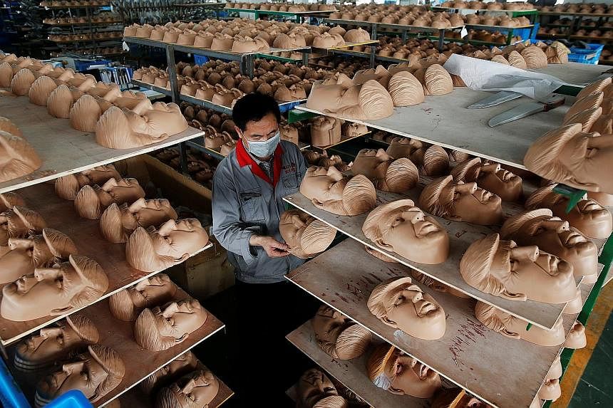 A worker checking a mask of United States Republican presidential candidate Donald Trump at a factory in China's Zhejiang province on Wednesday. The factory, which produces thousands of rubber and plastic masks of everyone from Osama bin Laden to Spi