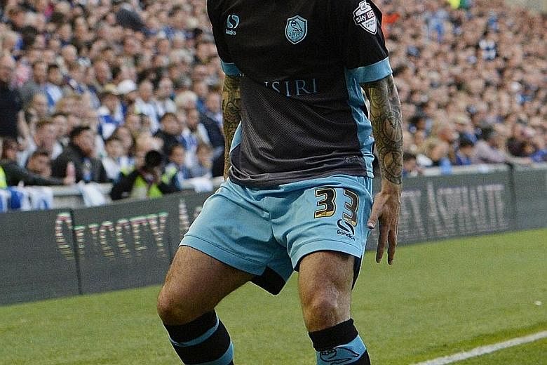 Sheffield Wednesday midfielder Ross Wallace celebrates his goal against Brighton and Hove Albion in their Championship play-off semi-final. He netted in both legs.