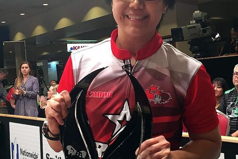 Singapore bowler Bernice Lim (left) showing her biggest individual trophy after beating top seed Sandra Andersson to claim the USBC Queens title, a major event on the PWBA tour. Team-mate Cherie Tan (right) was also victorious on Thursday, winning th