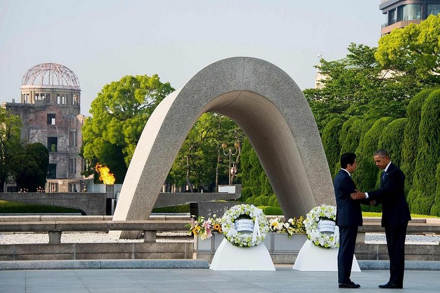 US President Obama hugging a survivor of the 1945 atomic bombing of Hiroshima in an emotional moment during a visit to the Hiroshima Peace Memorial Park yesterday. He is the first sitting American president to make the trip. Mr Obama with Japanese Pr