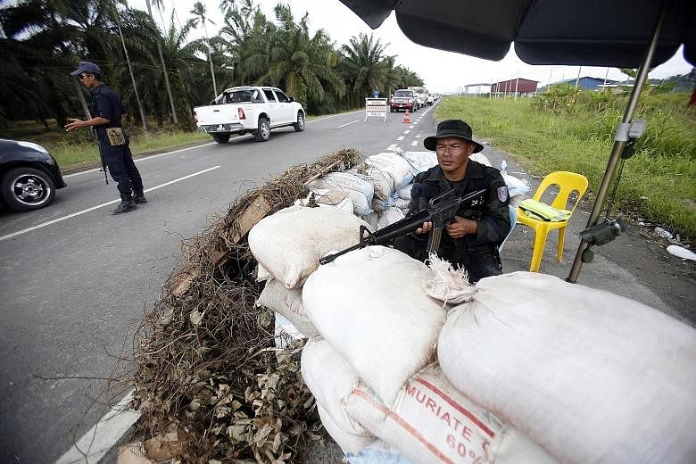 Malaysian security forces manning a road in Lahad Datu, Sabah, in March 2013 after militiamen from Sulu besieged the area, leading to deadly clashes. A concern now is how Mr Duterte will pursue the Sabah claim.