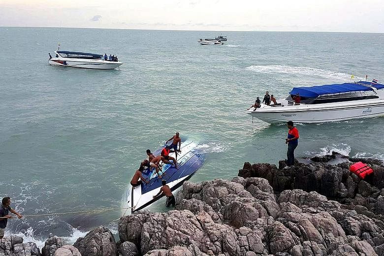 Rescue workers helping foreign tourists who were on the packed speedboat that capsized off Koh Samui on Thursday.