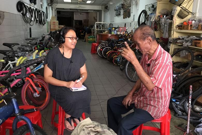 Ms Kuah interviewing a trader for a project to document 100 people who have lived at least 40 years in George Town. 