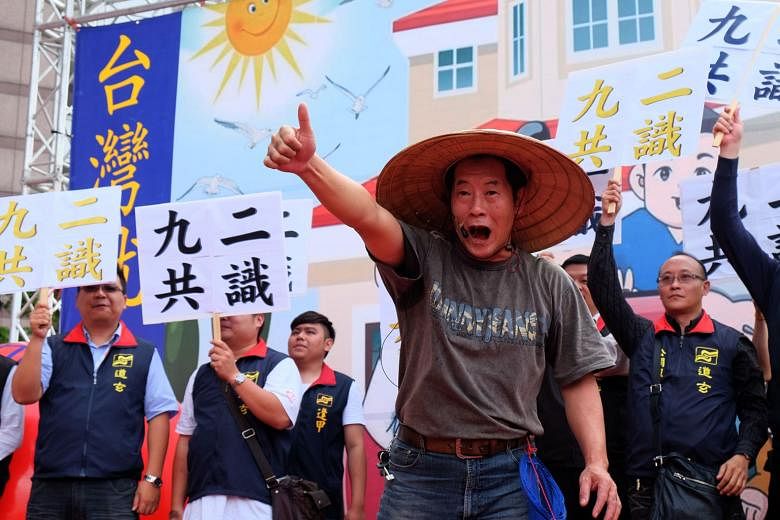 Pro-unification activists holding placards that read "92 consensus" during a protest outside the DPP headquarters in Taipei earlier this month. Ms Tsai's ambiguous stance on the 1992 consensus has prompted criticism from pro-independence forces, but incre
