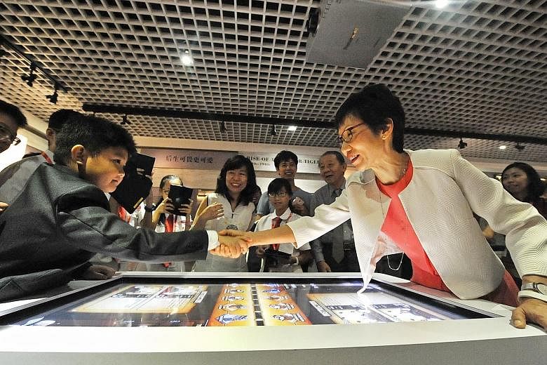 Eight-year-old Trevor Tan shaking hands with Minister for Culture, Community and Youth Grace Fu after she beat him in a multimedia game. Trevor is the great-great-great-grandson of Teo Eng Hock, who was one of the founding members of the Kuomintang. 
