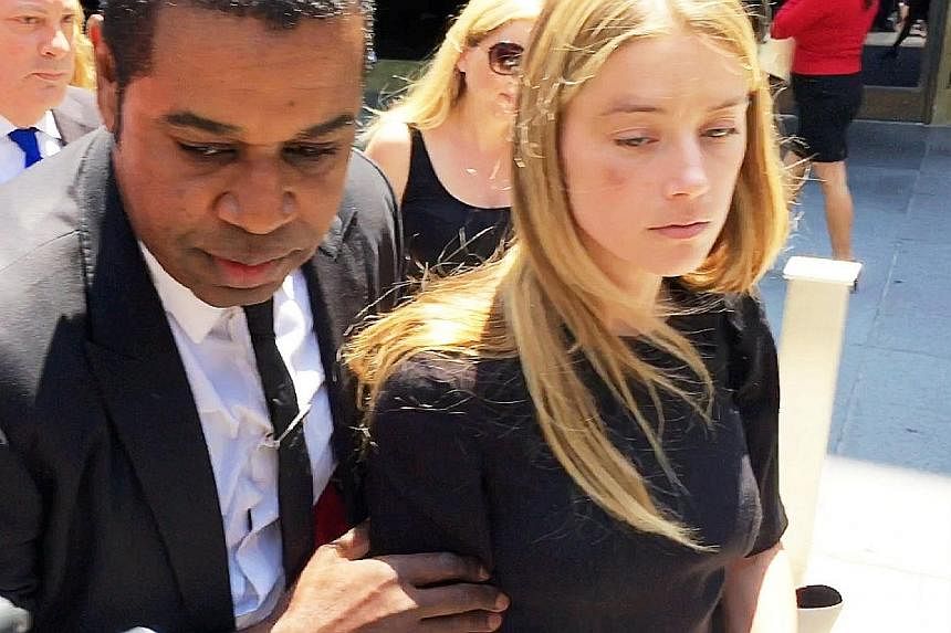 Amber Heard leaving court with a black eye after getting a restraining order against Johnny Depp (left).