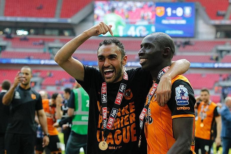 Hull midfielders, Egyptian Ahmed Elmohamady and Senegalese Mohamed Diame, celebrating after the team beat Sheffield Wednesday in the English Championship play-off final. After bouncing back straight after relegation, manager Steve Bruce wants to lear