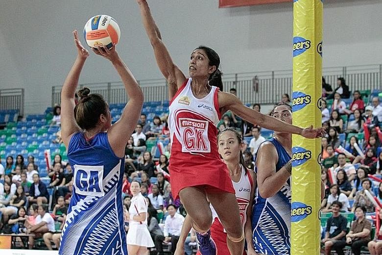 Singapore goal defender Premila Hirubalan (right) attempts to block a shot at the 2014 Nations Cup.