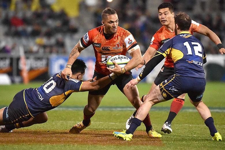 Derek Carpenter being tackled by Brumbies' Christian Lealiifano (left) and Robbie Coleman during the Sunwolves' 5-66 thumping in their Super Rugby match on Saturday.