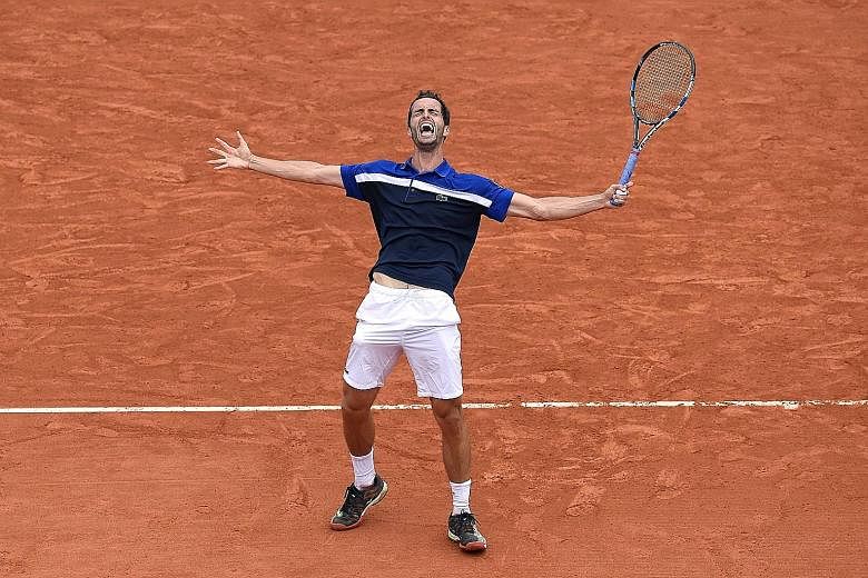 World No. 55 Albert Ramos-Vinolas celebrating his victory over eighth seed Milos Raonic. The Spaniard arrived in Paris with just four wins in Grand Slam matches.