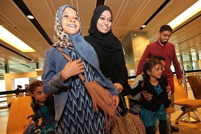 Madam Sherin (wearing black) with her children (from left) Iman, Afaaf, Wafaa and Ahmad (partially blocked) arriving at Changi Airport Terminal 1 in April last year. They had been evacuated from Yemen, where tensions were high with clashes between th