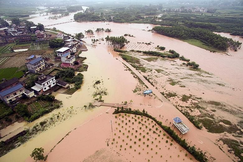 Chinese weather agencies have warned of more rain and even hail, after tens of thousands were displaced in large-scale floods.