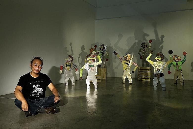 Indonesian artist Heri Dono with his artwork Wayang Zaman Edan.