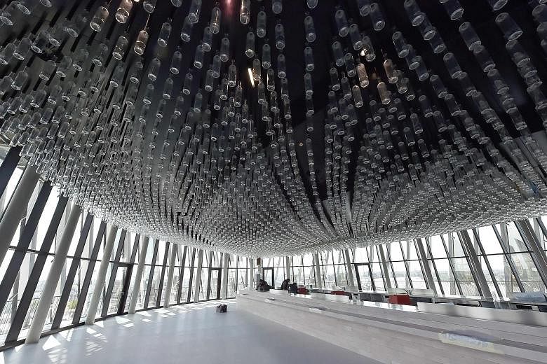 A picture taken last week showing a room with a panoramic view where the ceiling lights are made of thousands of bottles in the new Bordeaux wine museum in France. The museum - a new cultural, touristic and architectural symbol of the city in the fam