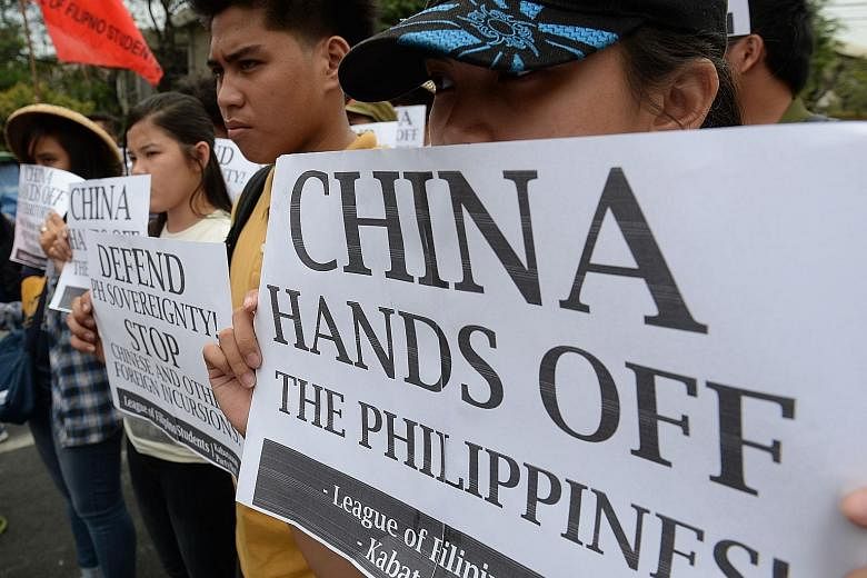 Filipino students holding anti-Chinese placards during a rally in Manila in March against Chinese vessels reportedly dropping anchor near a South China Sea atoll also claimed by the Philippines.