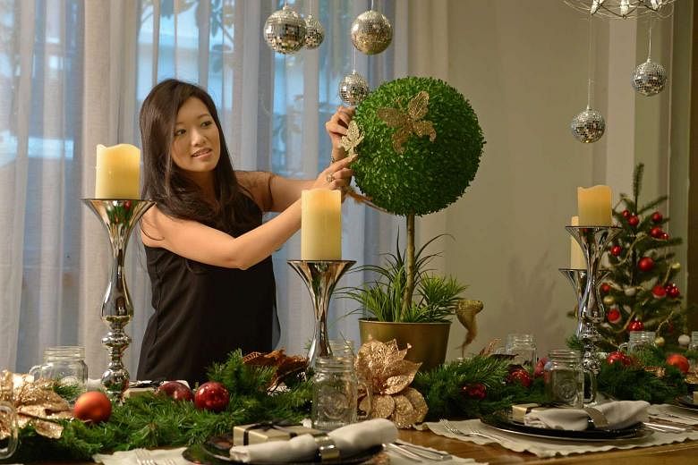 Events company entrepreneur Elaine Kim decorates her dinner table with her own floral arrangements. 