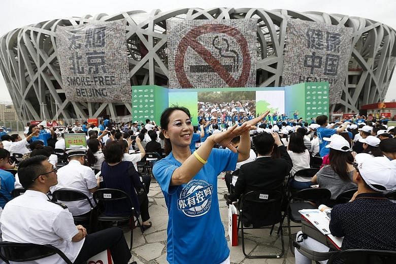 An anti-smoking advocate dancing at the Bird's Nest stadium to mark World No Tobacco Day in Beijing yesterday. According to the WHO, China is the world's largest producer and consumer of tobacco products. More than 300 million people in the country a