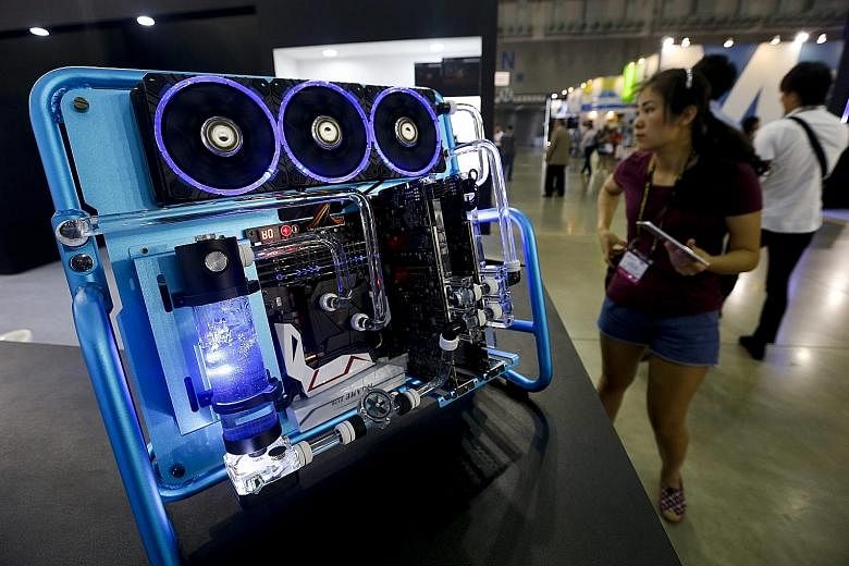 A visitor checking out a computer with a liquid cooling system at Taipei's Computex expo - the largest computer trade show in Asia - yesterday. The five-day event, which ends on Saturday, gathers 1,602 exhibitors from 30 countries occupying 5,009 boo