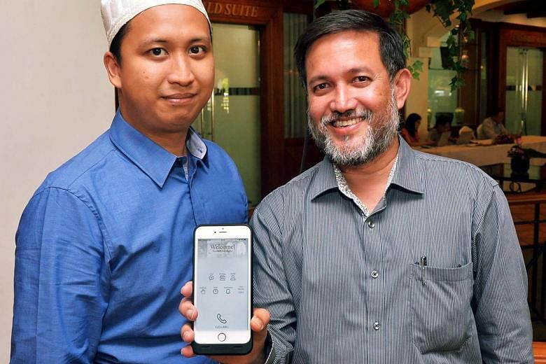 Showing off the new app are Mr Salim Mohamed Nasir (right), head of the Religious Rehabilitation Group (RRG) secretariat, and Mr Ahmad Saiful Rijal Hassan, a counsellor and RRG secretariat member.