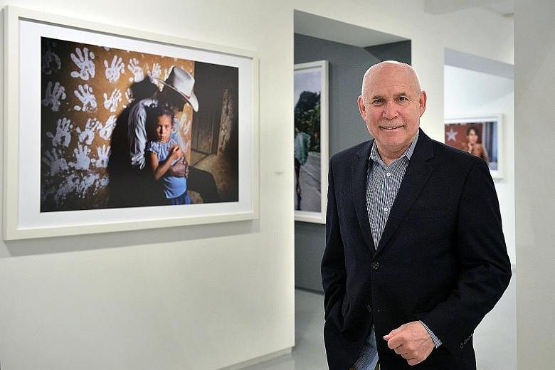 Mr Steve McCurry, known for photographs such as the Afghan Girl and a young monk running along a wall (above), now calls himself a visual storyteller rather than a photojournalist.