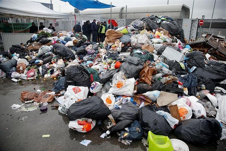 Striking CGT garbage collectors and sewer workers blocking access to the waste treatment centre of Ivry-sur-Seine, near Paris, yesterday in protest against the labour reform Bill.