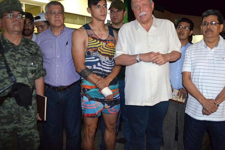 Mexican footballer Alan Pulido with Tamaulipas state Governor Egidio Torre Cantu (right), after receiving treatment for his cut wrist which he suffered while escaping. One of his captors was caught. 