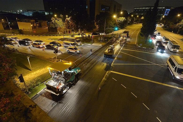 Workers resurfacing the affected section of Jalan Boon Lay last night. It was scheduled to be completed by 2am.