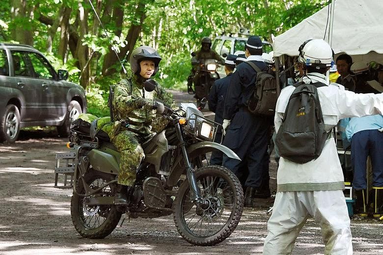 Motorbike-riding soldiers of Japan's Self-Defence Forces yesterday joined the search for a seven-year-old boy who went missing last Saturday. He had been left behind by his parents in a forested area of Hokkaido as punishment for being naughty.