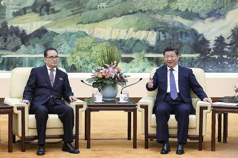 President Xi Jinping (left) told visiting North Korean senior envoy Ri Su Yong (far left) that China was willing to "work with North Korea" to maintain friendly ties.