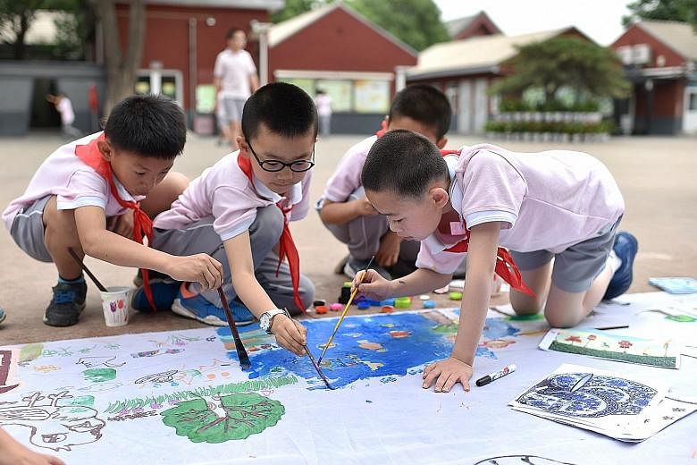 Primary school pupils in Beijing using art to express what they imagine life would be like in outer space in an event to mark International Children's Day yesterday.