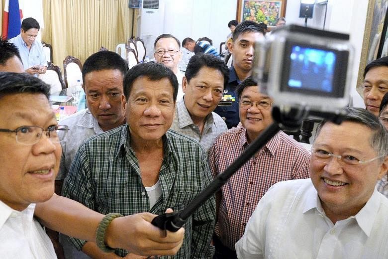 A handout picture made available by the Davao City Mayor's Office on Wednesday shows President-elect Rodrigo Duterte (centre) and his Cabinet members taking a wefie in Davao City on Tuesday.