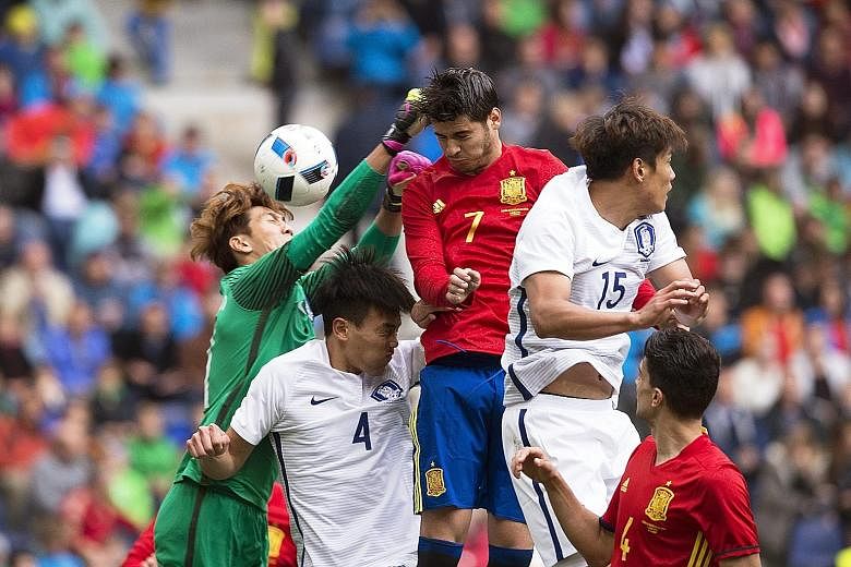 Spain's Alvaro Morata (centre) scoring past South Korea's goalkeeper Kim Jin Hyeon (left). Morata scored twice in the friendly as he repaid the faith of coach Vicente del Bosque, who overlooked Chelsea forward Diego Costa for his Euro 2016 squad in f