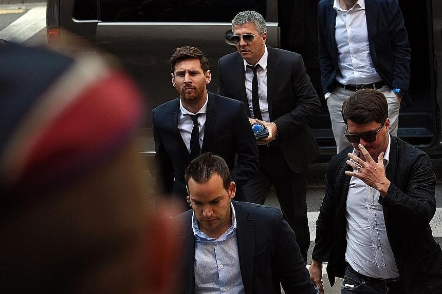 Football star Lionel Messi (left) arriving at the courthouse in Barcelona yesterday with his father Jorge (behind) and his brother Rodrigo (right). The trial has cast a spotlight on the financial dealings of elite sport stars.