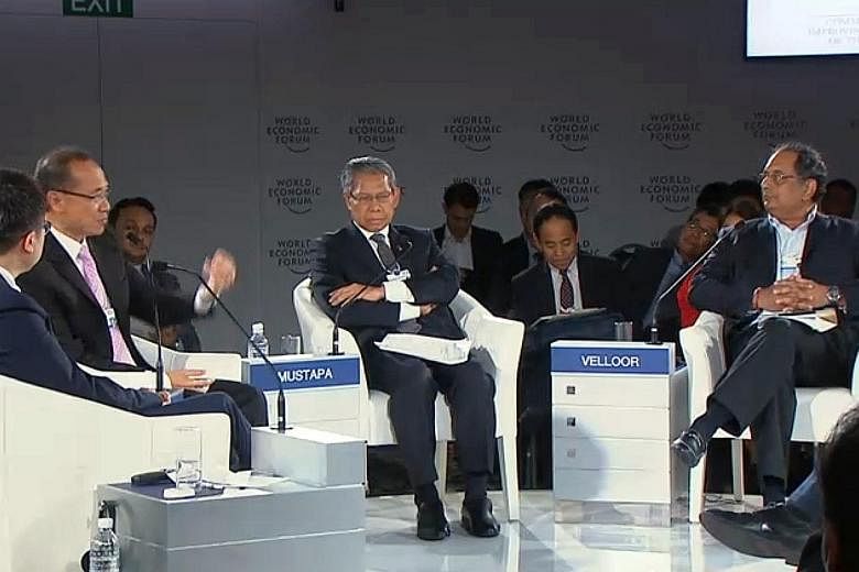 Mr George Yeo (second from left) speaking during a panel session at the World Economic Forum on Asean yesterday. The session's moderator was ST associate editor Ravi Velloor (right). The speakers included Mr Calvin Chi Kin Choi (left) and Tan Sri Mus