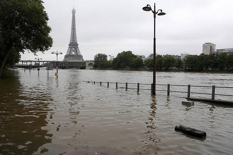 The Seine, on whose banks are found many of Paris' famous attractions such as the Eiffel Tower (in the background), the Louvre and the Musee d'Orsay, was expected to swell more than 6m above its normal level yesterday.