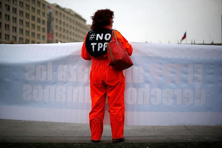 An anti-TPP demonstrator at a rally in front of Government House in Santiago, Chile, last month. Non-ratification of the trade deal by the US Congress would signal that Beijing gets to dictate policy in Asia, and the attempt to integrate Vietnam in a