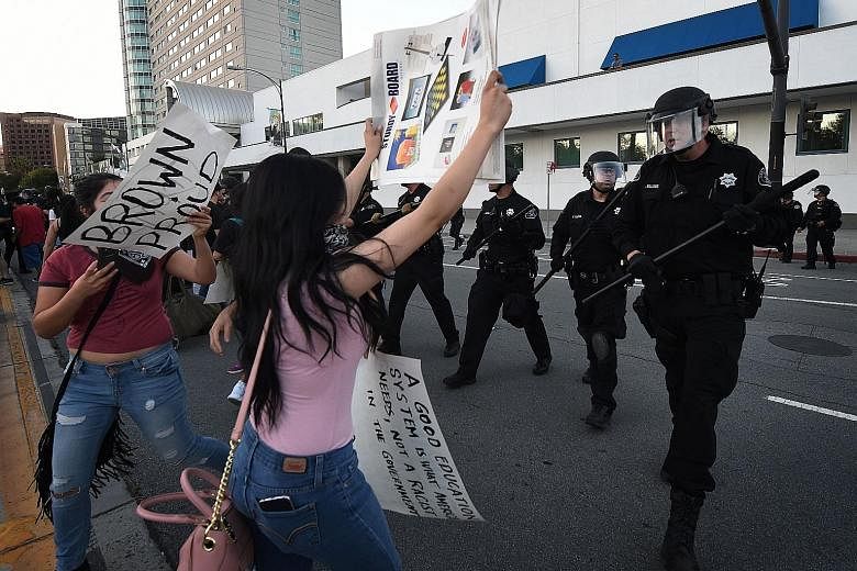 Police officers moving in to disperse anti-Trump protesters as they demonstrated outside the convention centre where Republican presidential candidate Donald Trump was holding an election rally in San Jose, California, on Thursday. Protesters who opp