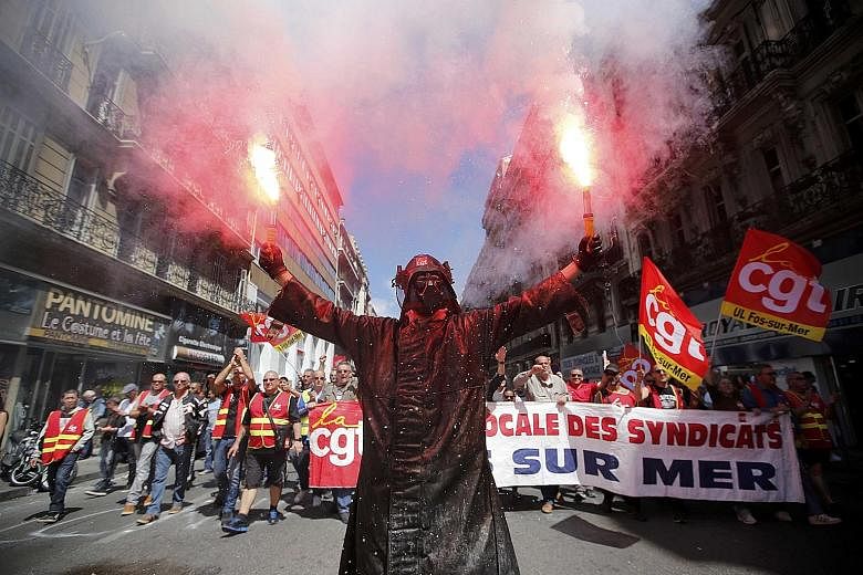 A worker in a Darth Vader mask at a protest led by the militant CGT union group. Strikes all over France have disrupted public services as people protest against changes to labour law that would make it easier to hire and fire workers.