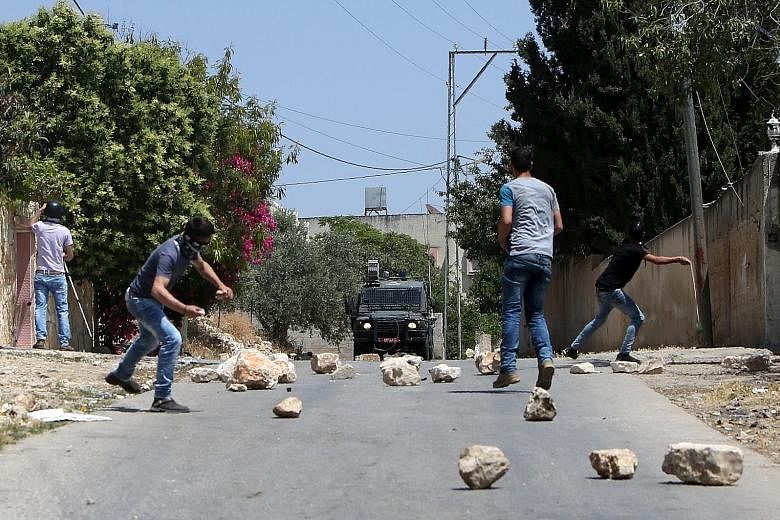 Palestinian protesters hurling stones at Israeli security forces during clashes. Although Palestine is willing to have a peacekeeping force - from Nato states that are friendly to Israel - to replace Israeli troops in the West Bank, Israel is opposed