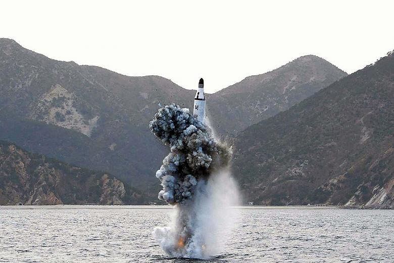 An April 24 photo from North Korea's official news agency shows the underwater test-firing of a strategic submarine-launched ballistic missile. This week, Pyongyang released a video of the test - shortly before the North Korean envoy was to meet Chin