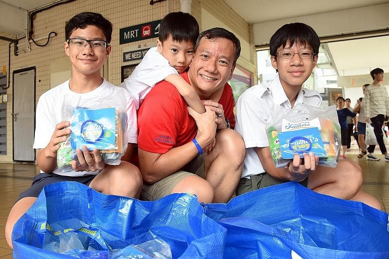 Dads found wearing the Celebrating Fathers movement's wristband got goodie bags yesterday. One such dad was Mr Adrian Gerard Seah, seen here with his sons (from left) Alexander, Alpherius and Angelo.