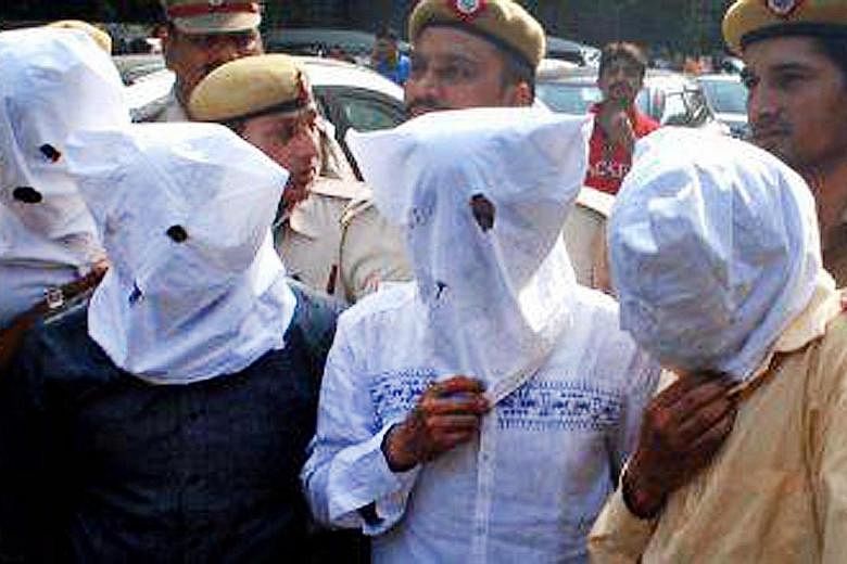 Suspected members of an organ trafficking gang wearing masks after their arrest in New Delhi. A shortage of organs for transplant fuels a booming black-market trade in body parts in India.